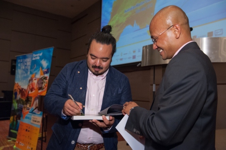 Chef Adam Liaw signs a copy of his cookbook, Two Asian Kitchens, for Chief Executive Officer of AirAsia X, Mr Azran Osman-Rani.