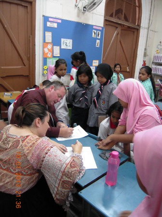 Ms Stephanie Arthur (left) and Mr Christopher Dunne (in maroon shirt), both student teachers from Queensland University of Technology in Australia, with students from SK Convent Bukit Nenas in Kuala Lumpur.