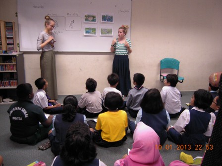 Two student teachers from Australia (standing) with a group of students.